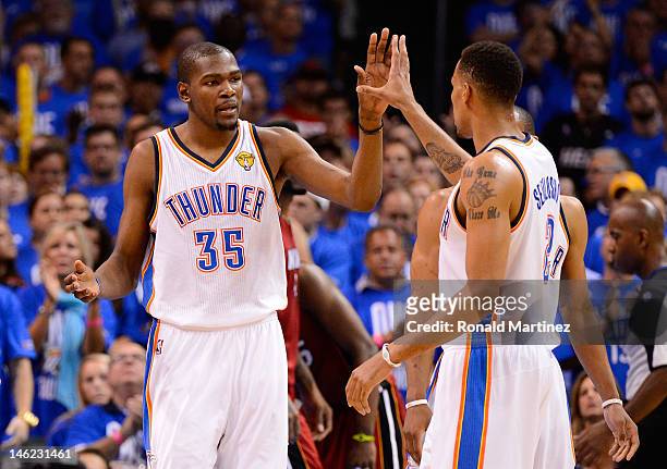 Kevin Durant and Thabo Sefolosha of the Oklahoma City Thunder give each other a high five in the third quarter in Game One of the 2012 NBA Finals at...
