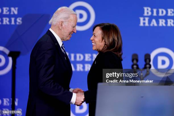 Vice President Kamala Harris greets U.S. President Joe Biden as he walks onstage during the Democratic National Committee winter meeting on February...