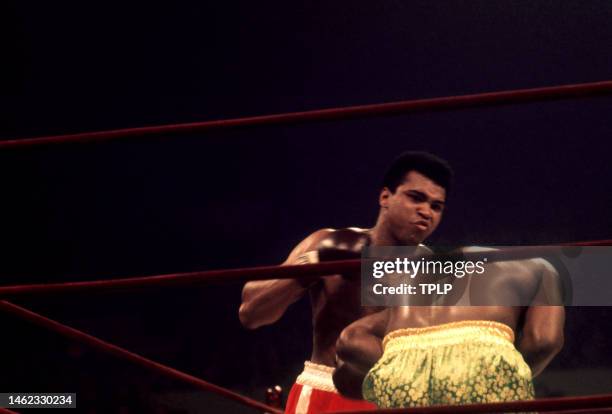 American heavyweight boxing champion Muhammad Ali throws a punch on current champion Joe Frazier during their 'Fight of the Century' bout at Madison...