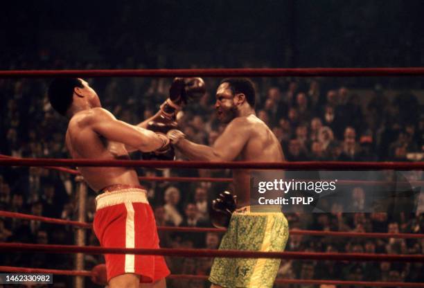 American heavyweight boxing champion Muhammad Ali takes a punch from current champion Joe Frazier during their 'Fight of the Century' bout at Madison...