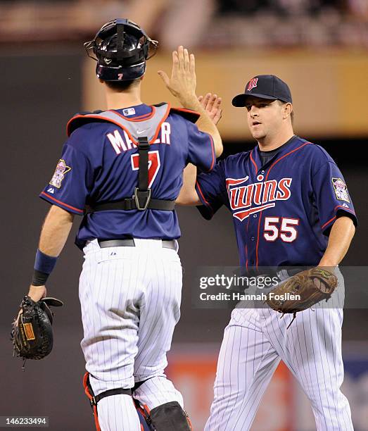 Joe Mauer and Matt Capps of the Minnesota Twins celebrate a win against the Philadelphia Phillies on June 12, 2012 at Target Field in Minneapolis,...