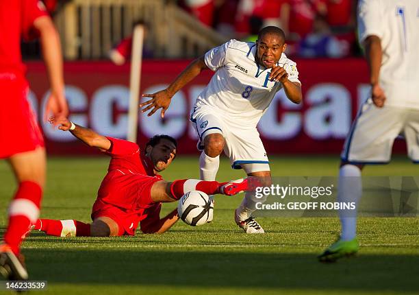 Wilson Palacios of Honduras takes the ball from Canada's Dwayne De Rossario during their FIFA 2014 World Cup Qualifier at BMO field in Toronto,...