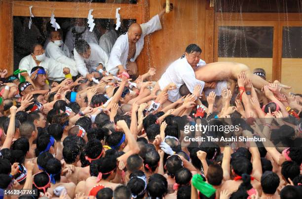 Man called a 'shin otoko' is swarmed by men in loincloths eager to ward off evil fortune, during an annual shrine ritual, dubbed 'hadaka matsuri' ,...