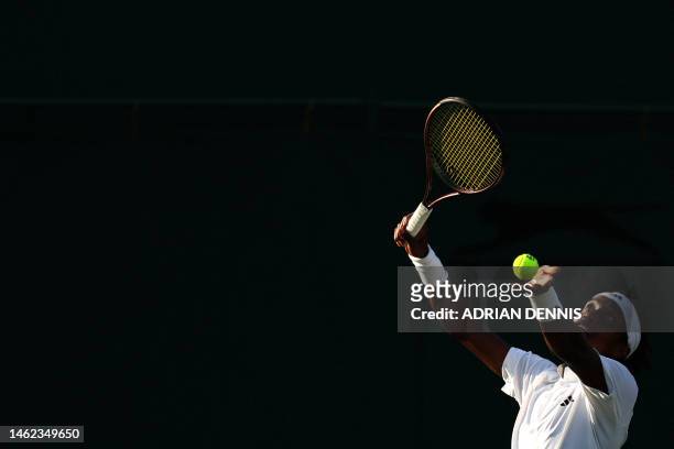 Switzerland's Mikael Ymer serves to Slovakia's Alex Molcan during their men's singles tennis match on the first day of the 2023 Wimbledon...