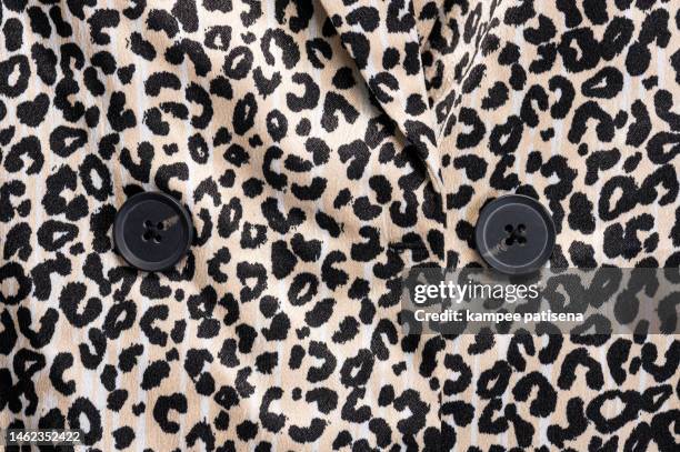 leopard print pattern fabric texture background - leopard print texture stock pictures, royalty-free photos & images