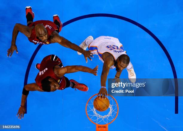 Kevin Durant of the Oklahoma City Thunder dunks the ball over Joel Anthony and Chris Bosh of the Miami Heat in the second quarter in Game One of the...