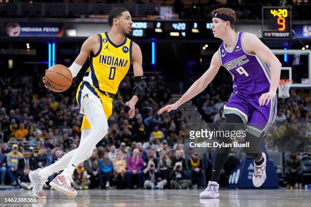 Tyrese Haliburton of the Indiana Pacers dribbles the ball while being guarded by Kevin Huerter of the Sacramento Kings in the fourth quarter of the...