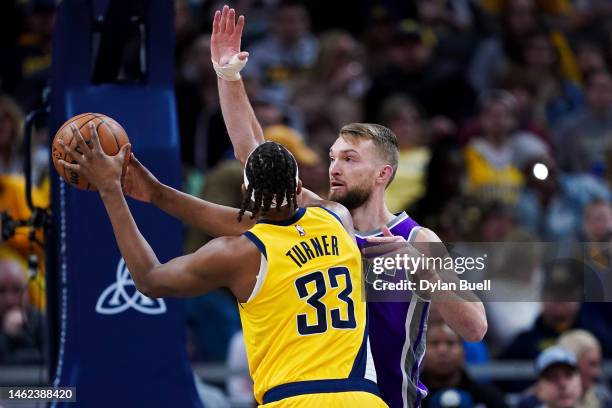 Myles Turner of the Indiana Pacers attempts a shot while being guarded by Domantas Sabonis of the Sacramento Kings in the first quarter of the game...