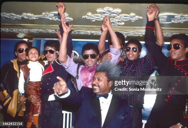 View of members of American Pop & R&B group the Jacksons, with actor Emmanuel Lewis and promoter Don King during a press conference to announce the...