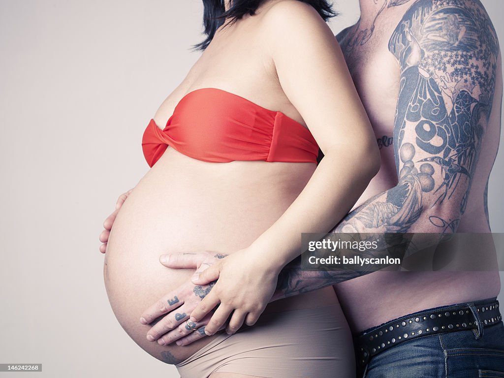 Man embracing his pregnant wife