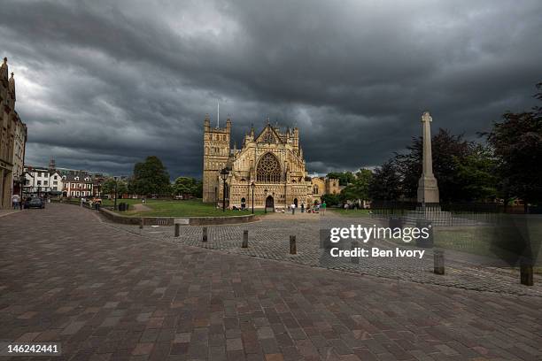 exeter cathedral yard under stormy sky - exeter cathedral stock pictures, royalty-free photos & images