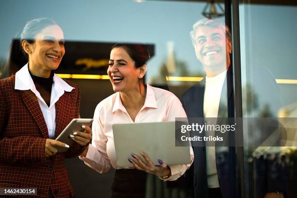 laughing business people with laptop and digital tablet at office - india people stock pictures, royalty-free photos & images