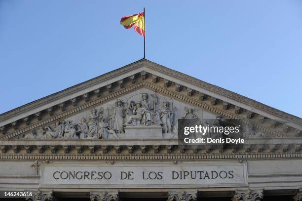 The national flag flies over the Spanish parliament on June 13, 2012 in Madrid, Spain. Spain has requested financial support from the European Union...