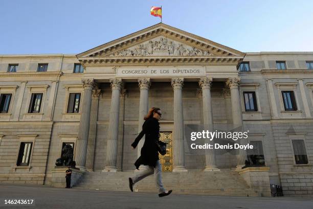 Commuter runs past the Spanish parliament on June 13, 2012 in Madrid, Spain. Spain has requested financial support from the European Union to shore...