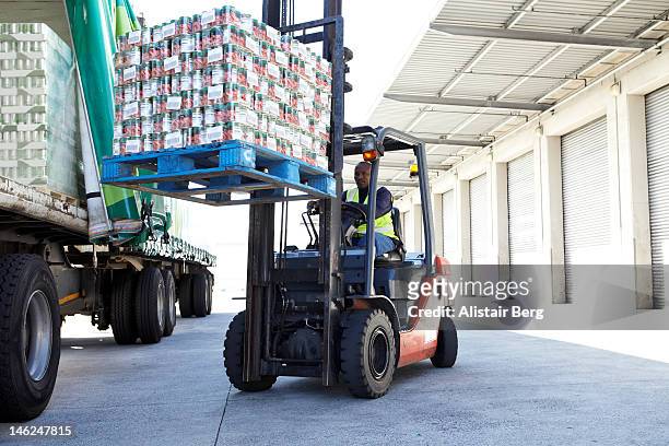fork lift truck loading a lorry - food transportation stock pictures, royalty-free photos & images