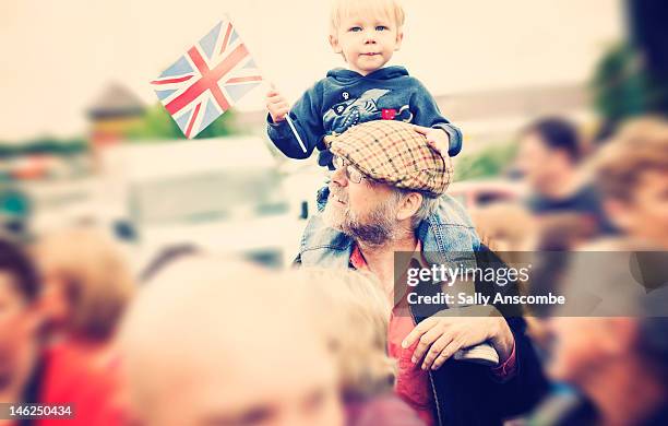 child sat on his grandpas shoulders - kid national flag stock pictures, royalty-free photos & images