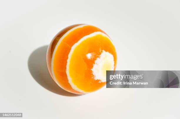 orange calcite crystal sphere - carbonato di calcio foto e immagini stock