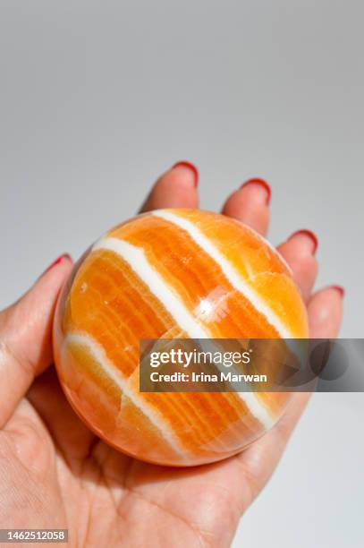 orange calcite crystal sphere - new age stock pictures, royalty-free photos & images