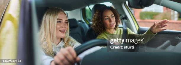 learner driver with instructor - driving instructor stock pictures, royalty-free photos & images