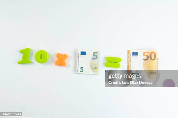 mathematical operations to know the value of the european currency. - moltiplicazione foto e immagini stock