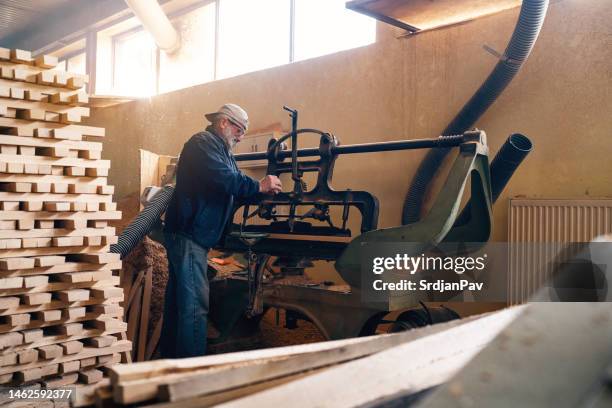 cooper shapes the oak wooden steves on the machine - wood shaving stock pictures, royalty-free photos & images