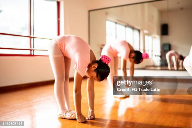 ballet dancers warming up at ballet studio - touching toes stock pictures, royalty-free photos & images