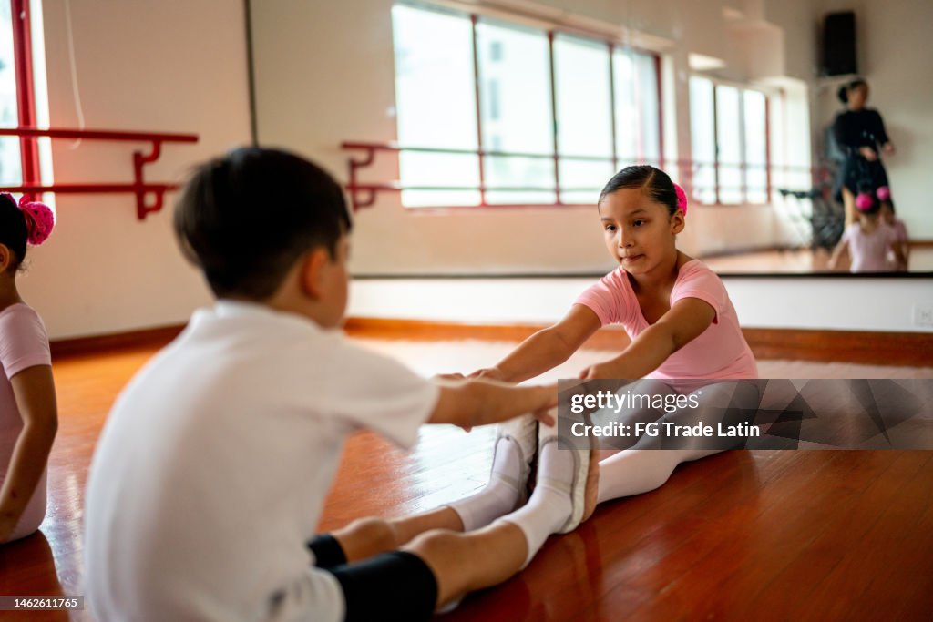 Ballet dancers stretching during a class at the dance studio