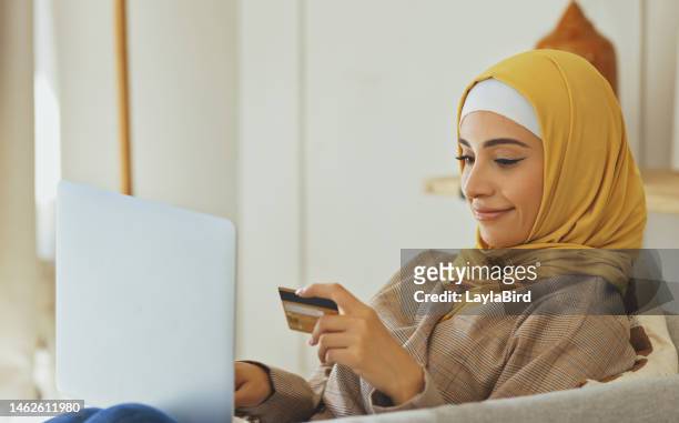 credit card, muslim woman and online shopping for e commerce, finance and payment on digital software. laptop, fintech and happy islamic person with sale, discount and website or banking technology - islamic finance stock pictures, royalty-free photos & images