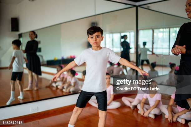 boy doing pirouette during ballet classes at the dance studio - ballet boy stock pictures, royalty-free photos & images