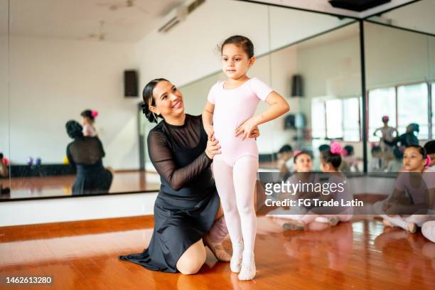 teacher giving instruction to ballet dancer at the dance studio - ballet stage stock pictures, royalty-free photos & images