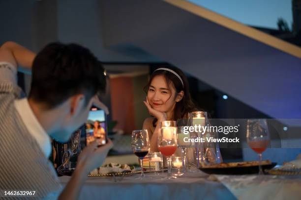 young couples to use mobile phones - country club dinner stock pictures, royalty-free photos & images