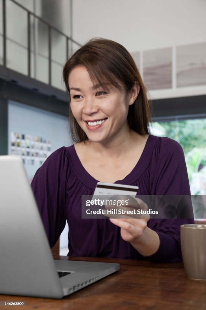 Japanese woman shopping online with credit card