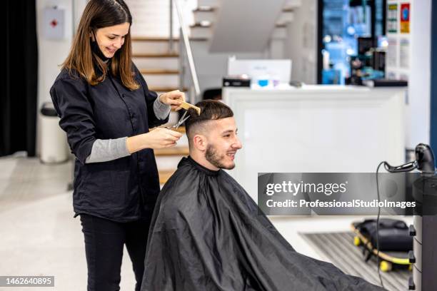 a young fashionable man is doing a haircut in a barbershop. - dresser isolated stock pictures, royalty-free photos & images
