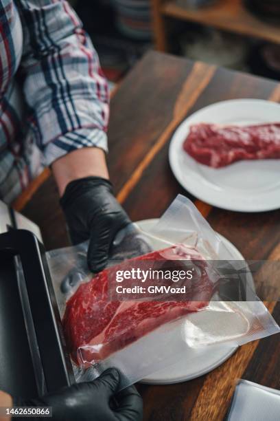 food safety - preserving fresh steaks in a plastic bag with a vacuume sealer - vacuum packed stock pictures, royalty-free photos & images