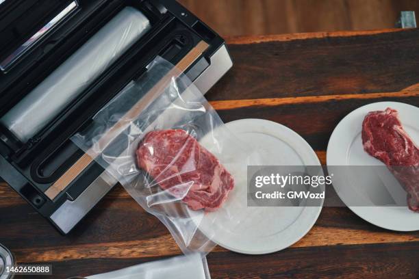 food safety - preserving fresh steaks in a plastic bag with a vacuume sealer - airtight stock pictures, royalty-free photos & images