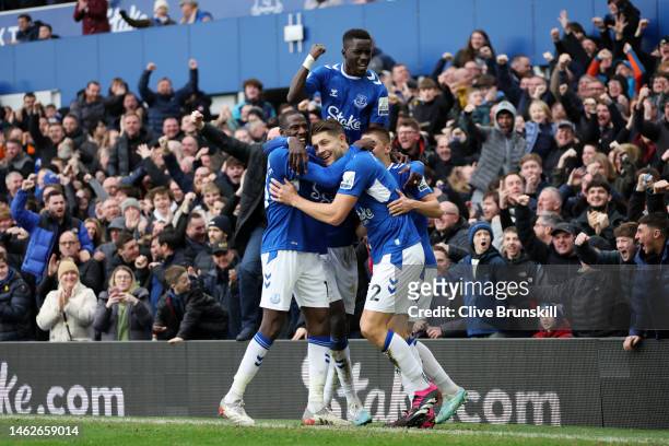 James Tarkowski of Everton celebrates with team mates after scoring the team's first goal during the Premier League match between Everton FC and...