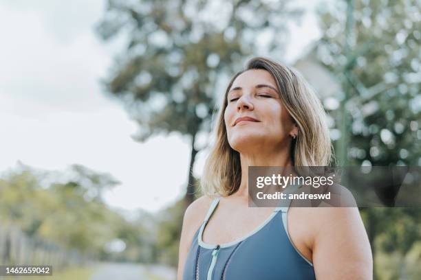 portrait of a woman breathing fresh air - fresh breath stockfoto's en -beelden