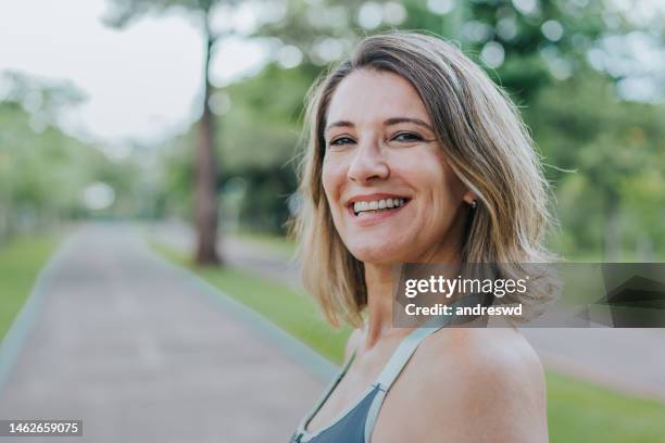ritratto di una donna sorridente - solo donne mature foto e immagini stock