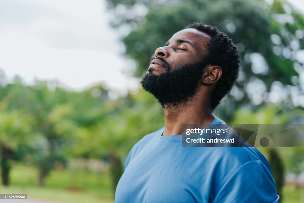 Portrait of a man breathing fresh air in nature