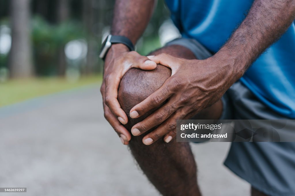 With hands on knee pain
