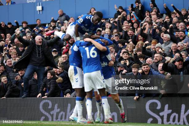 Everton fans celebrate after James Tarkowski of Everton scores their team's first goal during the Premier League match between Everton FC and Arsenal...