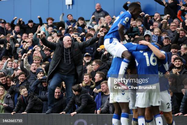 Everton fans celebrate after James Tarkowski of Everton scores their team's first goal during the Premier League match between Everton FC and Arsenal...