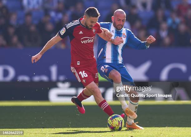 Moises Gomez of CA Osasuna compete for the ball with Aleix Vidal of RCD Espanyol during the LaLiga Santander match between RCD Espanyol and CA...