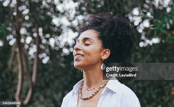 black woman, breathing and smile for fresh air in nature, travel or calm peace outdoors. happy african american female smiling in happiness taking deep breath for zen, health or spiritual wellness - spirituality stock pictures, royalty-free photos & images