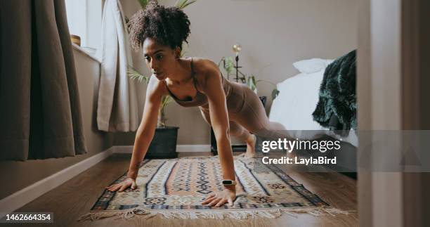 fitness, black woman and push up exercise in home for wellness, healthy lifestyle and workout. young sports person, plank and female athlete on bedroom floor with strong core, body muscle and power - opdrukken stockfoto's en -beelden