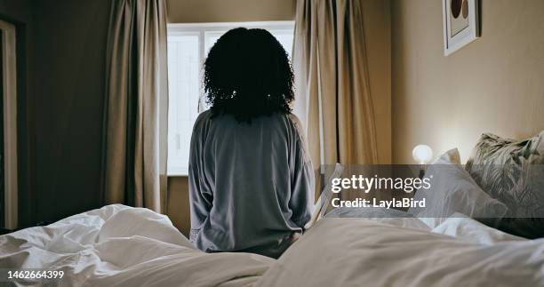 morning, depressed and woman wake up thinking on her bed in her bedroom looking out the window and sitting. sunrise, lonely and back view of lady relaxing reflective about memories in her home - bedroom curtains stock pictures, royalty-free photos & images