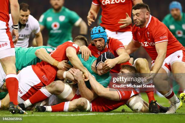 James Ryan of Ireland is tackled by Jac Morgan and Justin Tipuric of Wales during the Six Nations Rugby match between Wales and Ireland at...