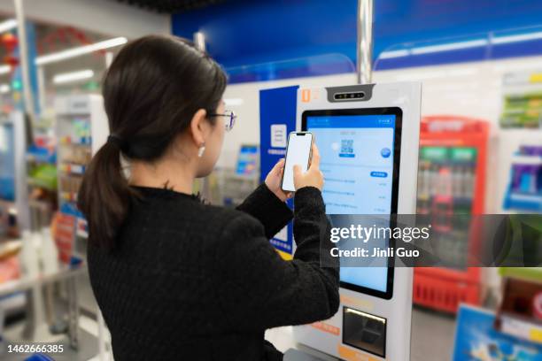 asian lady using unmanned scan code checkout in supermarket - digital counter stock pictures, royalty-free photos & images