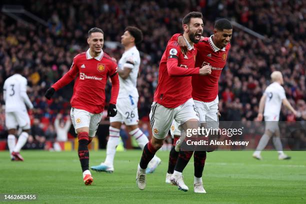 Bruno Fernandes of Manchester United celebrates with team mate Marcus Rashford after scoring their sides first goal during the Premier League match...