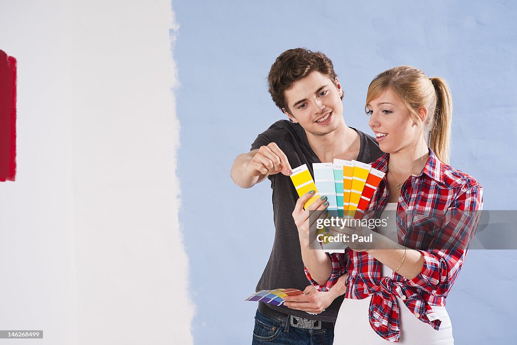 Young couple looking at different wall colors